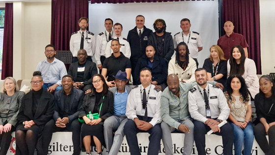 group of diverse individuals posing together in a community event showcasing collaboration and unity in a professional setting